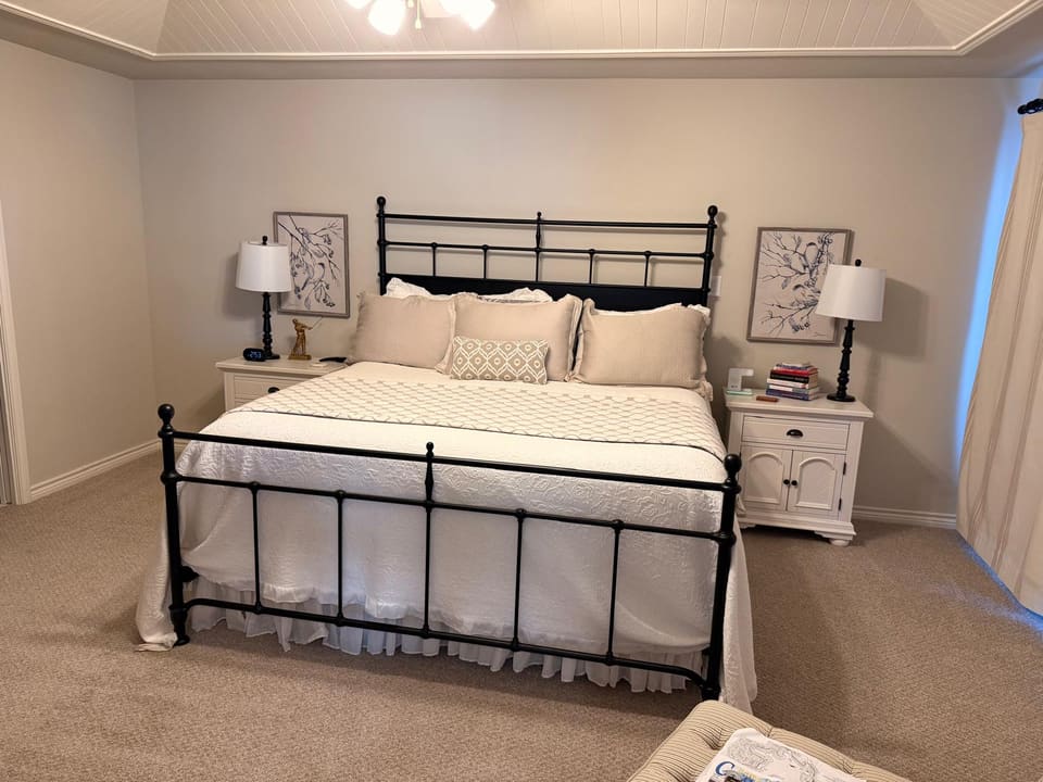 Tidy bedroom with fresh bedding after a regular cleaning